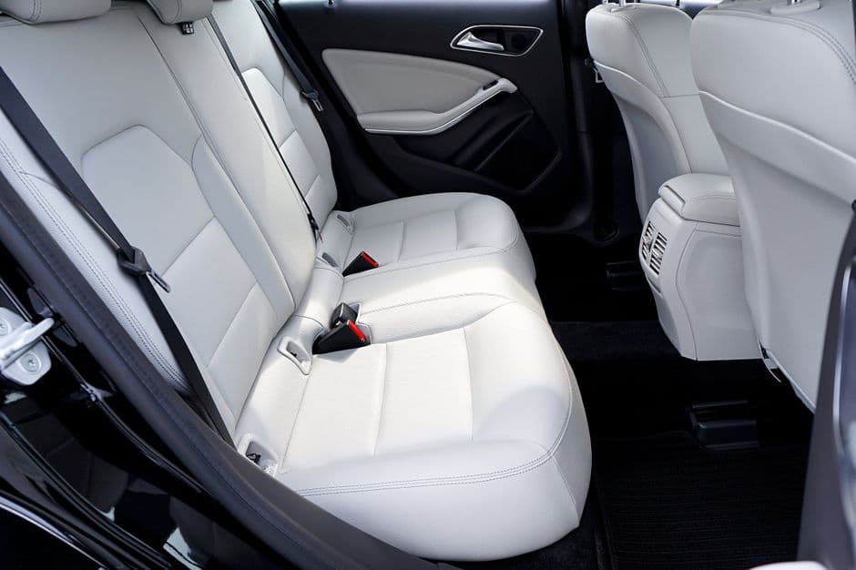 Clean white leather car seats showing the result of consistent conditioning