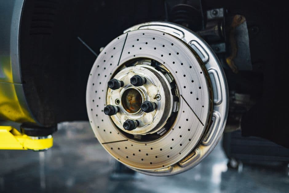 Worn brake rotor pulled off a car during a repair that could have been a pad-only job