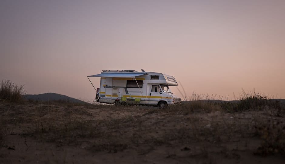 Motorhome parked at a campsite at sunset after a season of RV maintenance