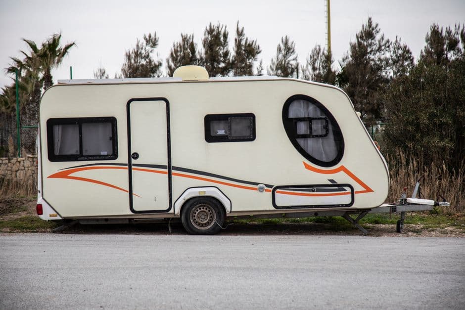 Travel trailer parked outdoors with wheels and tires visible for an RV tire inspection