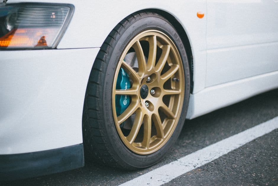 Close-up of a car tire and wheel where a TPMS sensor is mounted inside the rim