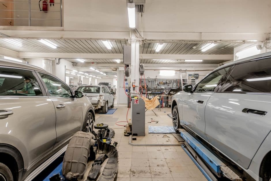 Service bay with cars raised for scheduled maintenance work