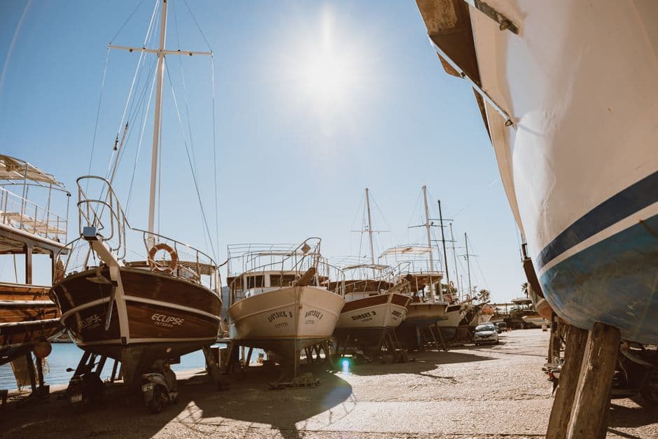 Row of boats in dry dock during seasonal hull maintenance