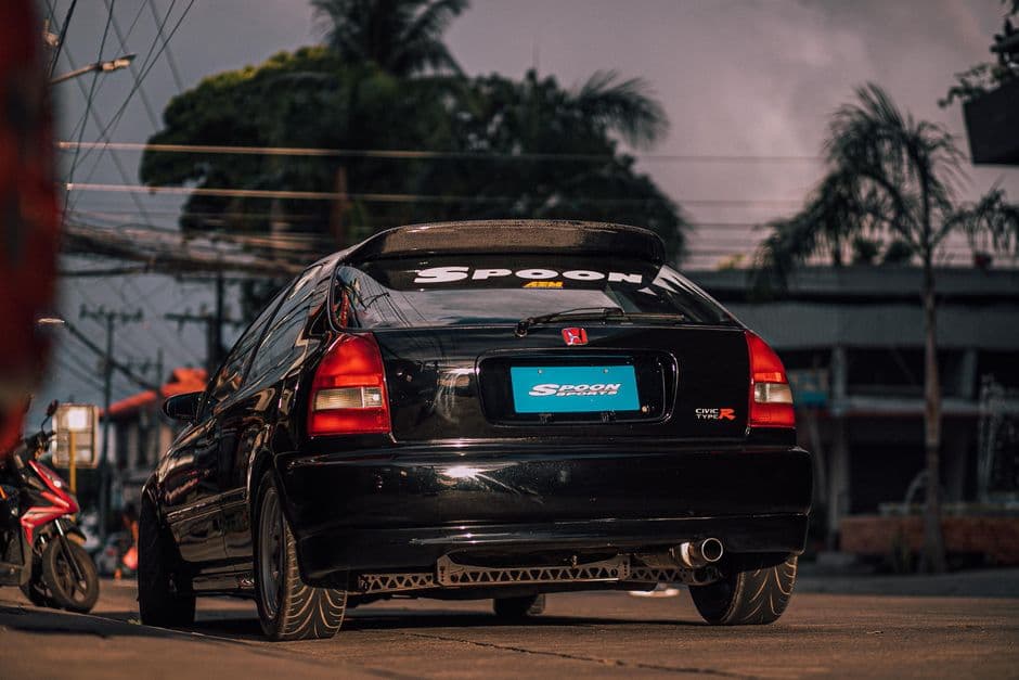 Honda Civic with an aftermarket rear spoiler and custom decals, a common platform for body kit modifications