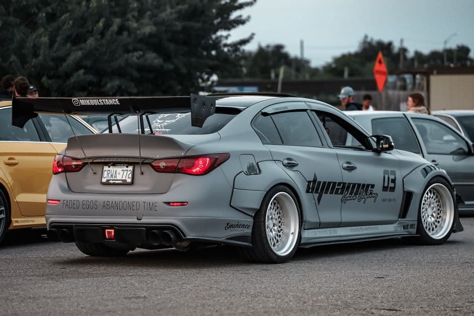 Modified sports car with a custom body kit and rear spoiler, an example of aero modifications on a street car