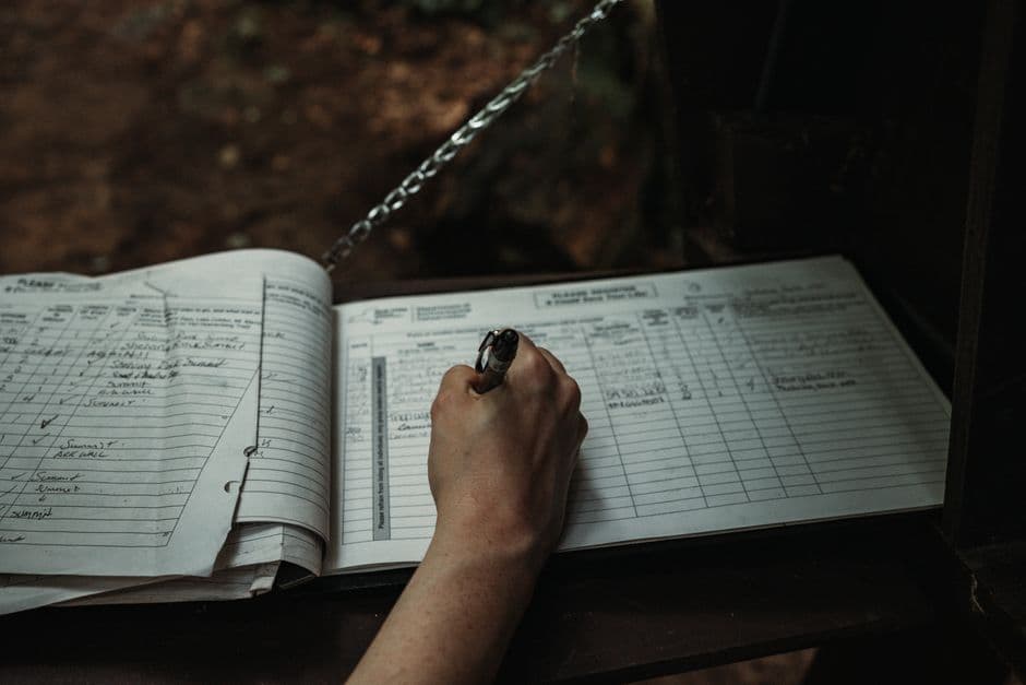 Handwritten entry in a vehicle maintenance log book recording service work