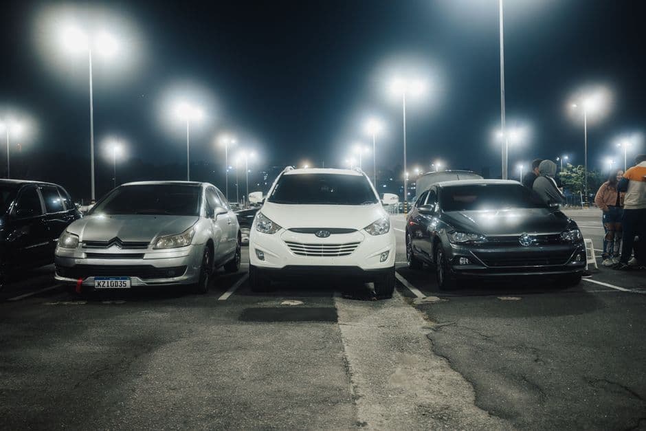 Mixed lot of sedans, SUVs, and trucks parked together, the range of vehicle types with different maintenance costs