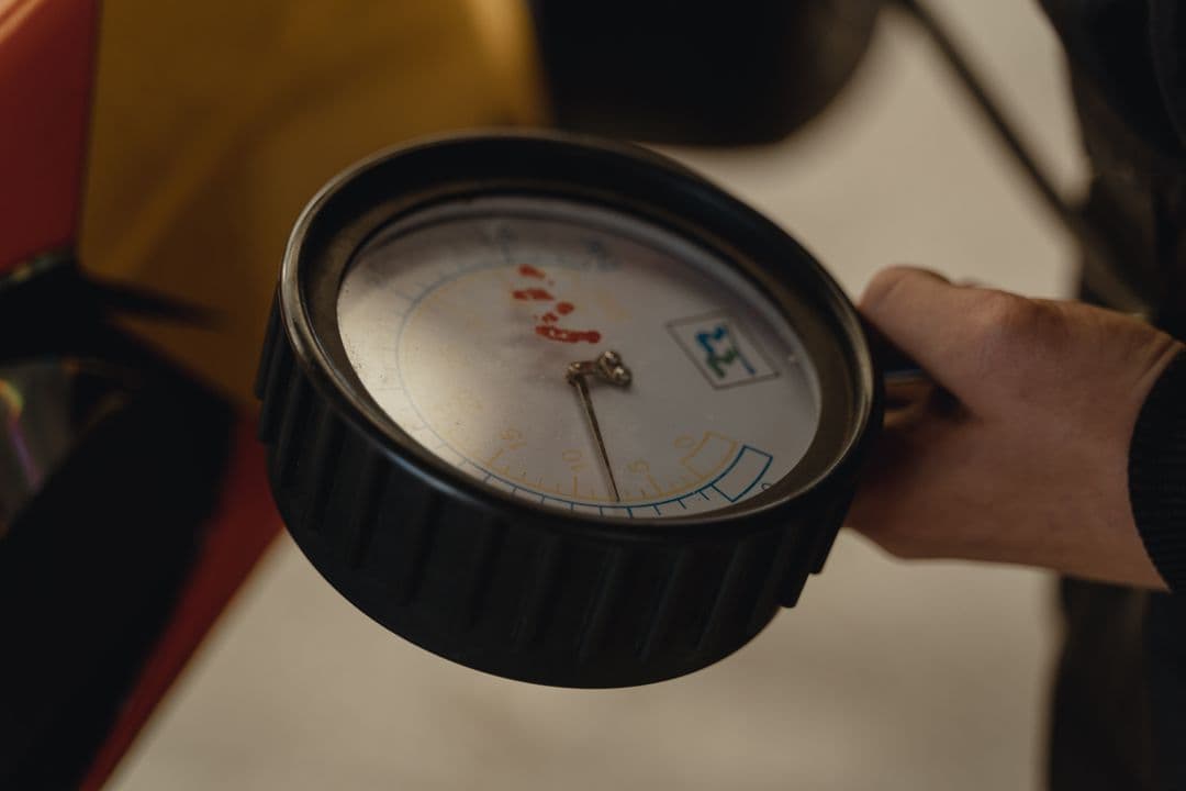 Checking tire pressure with a gauge, one of the easiest DIY car maintenance jobs for beginners