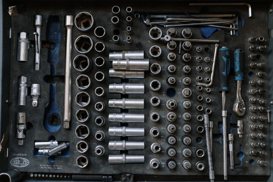 DIY car maintenance tool set laid out on a workshop bench