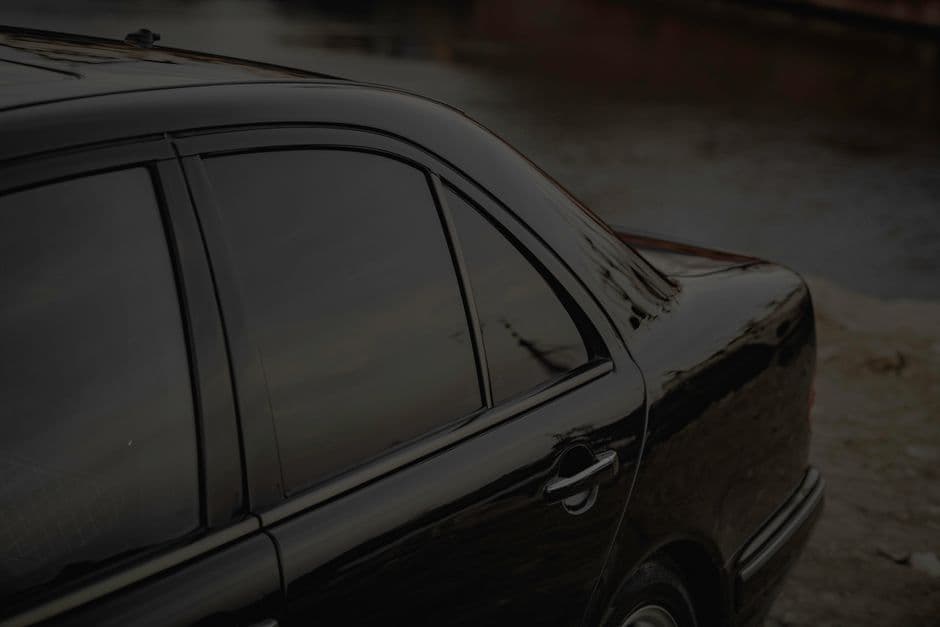 Close-up of a car window with tint film applied to the glass