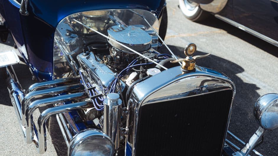 Detailed vintage Ford engine bay at a classic car show after restoration work