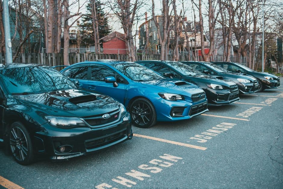 Row of company vehicles parked in an employer parking lot