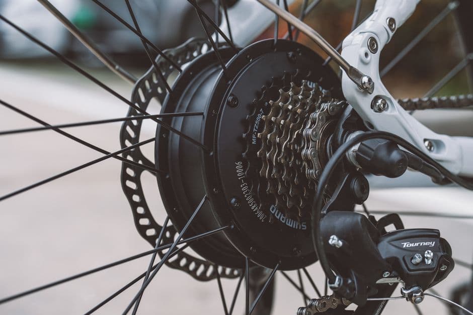 Close-up of an e-bike wheel and gear system showing chain and cassette components
