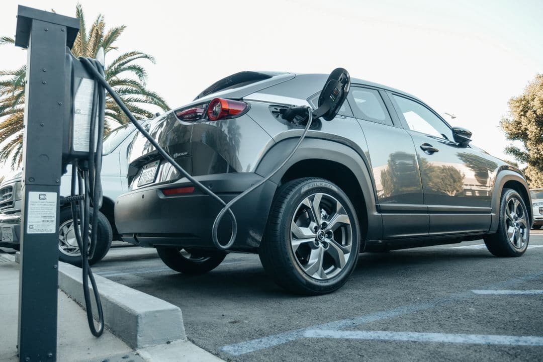 An electric car charging, the low-maintenance drivetrain behind modern EV ownership