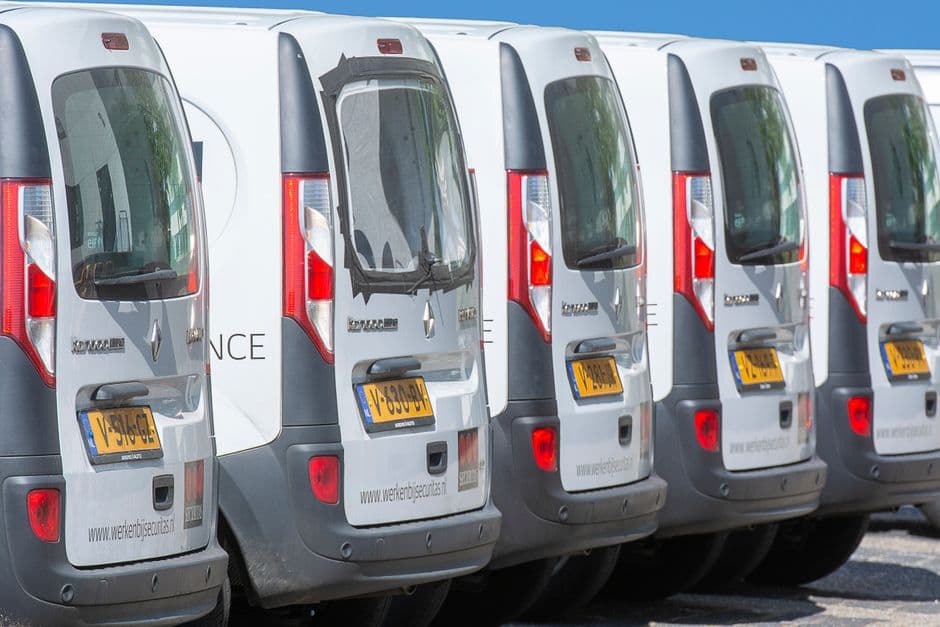 Small business fleet of delivery vans parked together, the kind of fleet that needs organized maintenance records