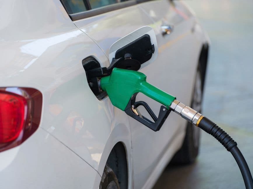 Close-up of a fuel nozzle refueling a car, the starting point for tracking fuel economy