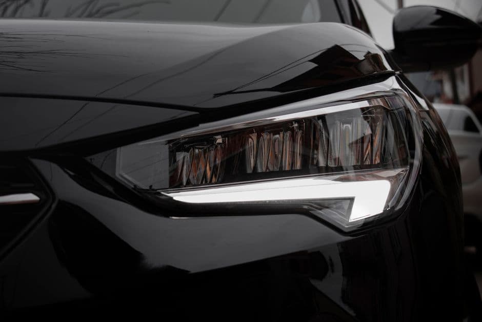 Close-up of a modern car's clear headlight lens after restoration