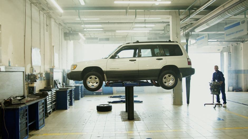 Car raised on a shop lift during routine maintenance work