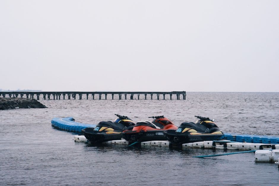 Personal watercraft docked at a marina, out of the water between rides