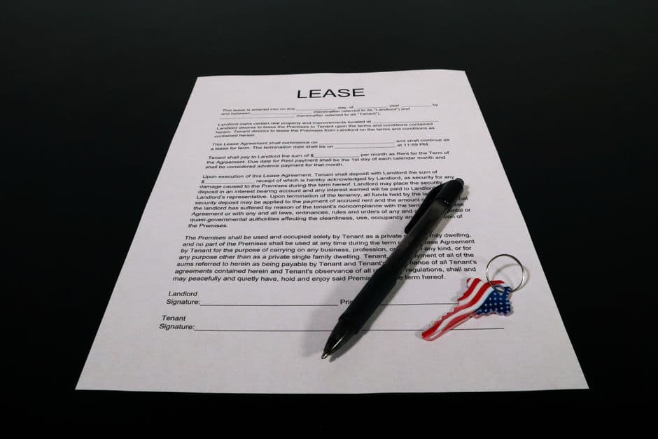Car lease agreement document with a pen on a desk