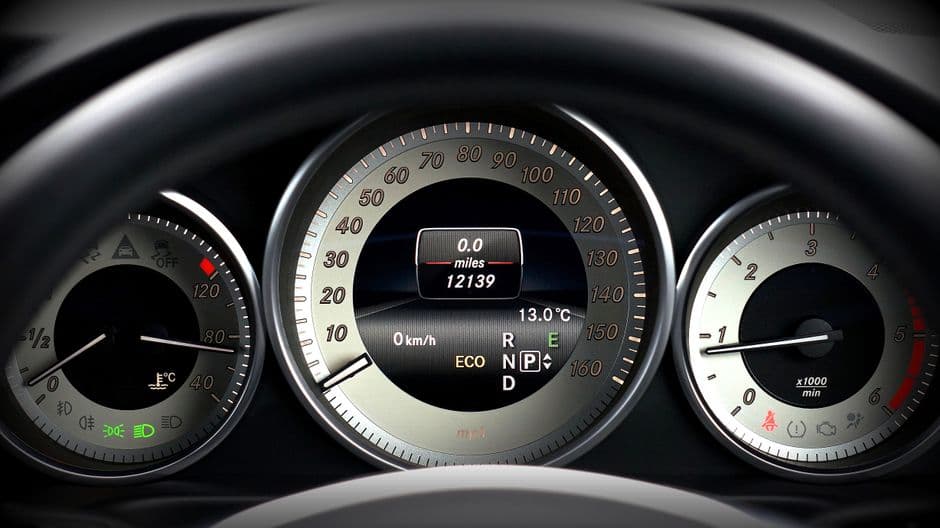 Car dashboard showing the speedometer and odometer used to log mileage for taxes