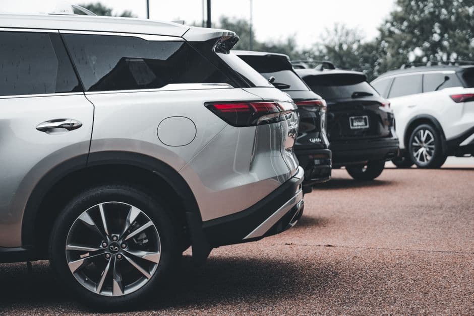 A row of parked SUVs, the kind of multi-vehicle household that needs separate maintenance records per car