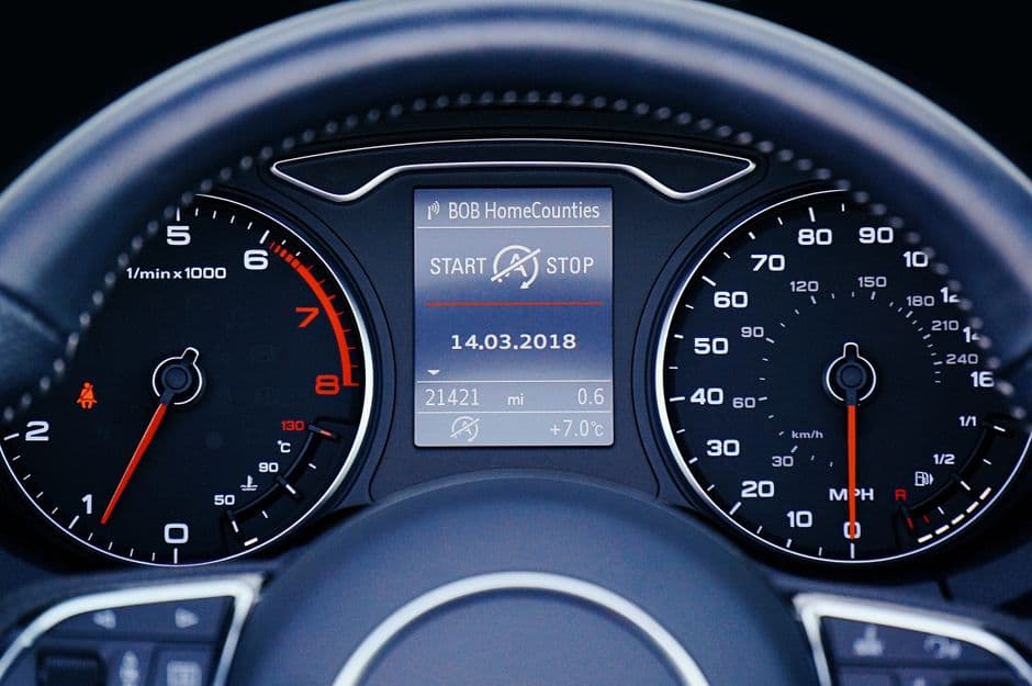 Car dashboard showing speedometer and odometer mileage during a break-in drive