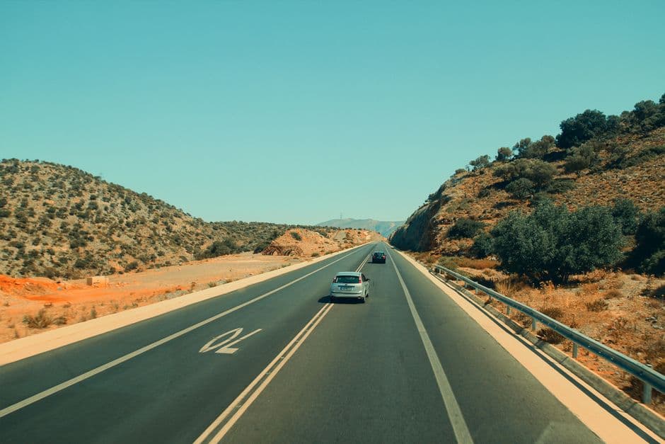 Highway stretching through a desert landscape on a long summer road trip