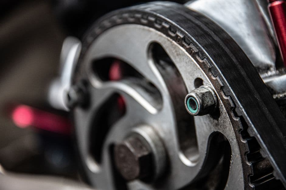 Close-up of a timing belt on a camshaft sprocket inside a car engine