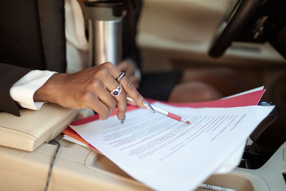 Car title and registration paperwork laid out on a desk